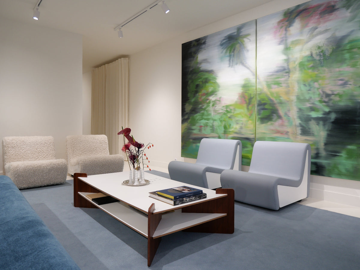 Source Édition showroom in Paris featuring Dialogue lounge chairs and sofa by André Monpoix (1967), TU-TU coffee table in white laminate by Turenne Chevallereau (1968), and Miniflore minimalist vases by Claude Courtecuisse (1970)