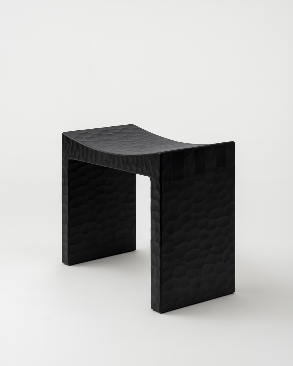 Basilio stool in solid linden wood with unique dark gouged wood finish