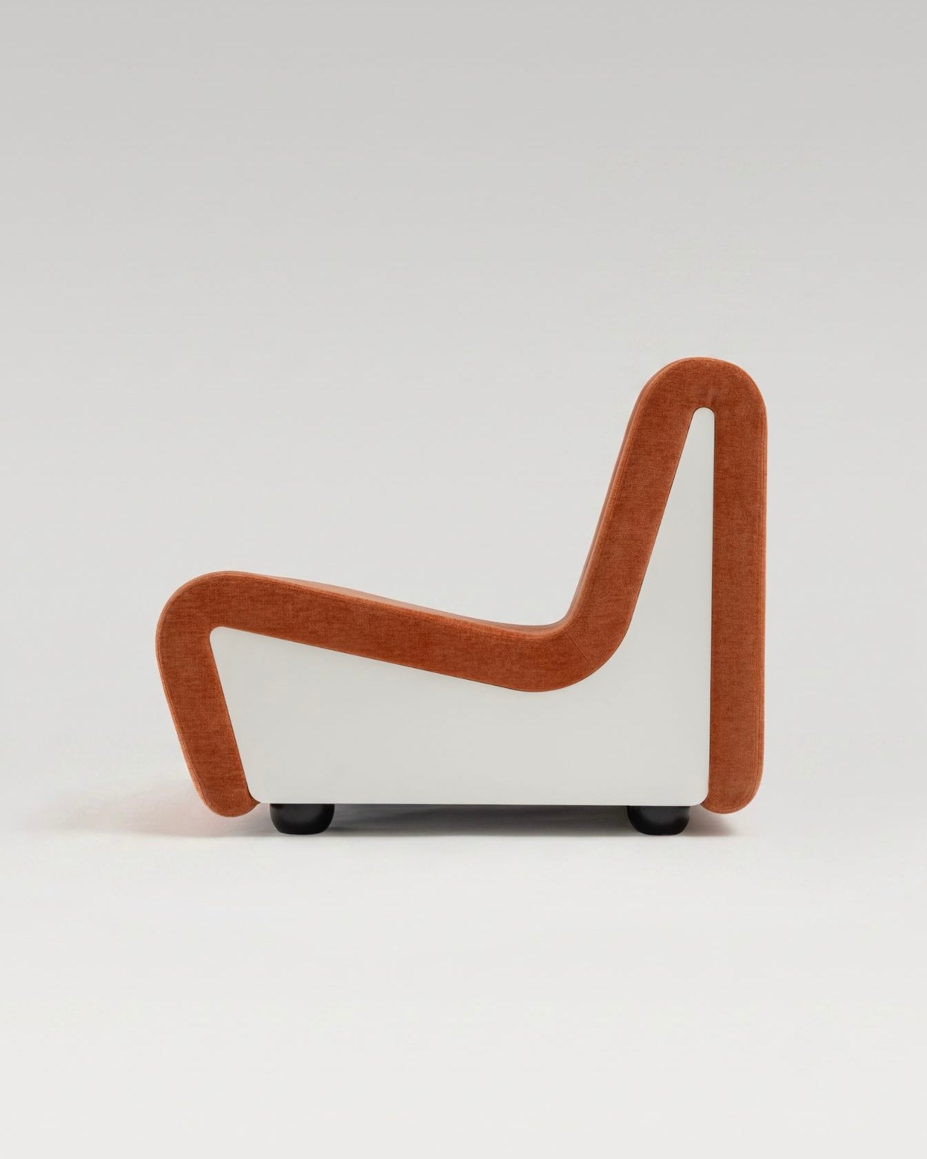 Dialogue lounge chair in Sienna orange fabric and white lacquered wood side panels, side view 
