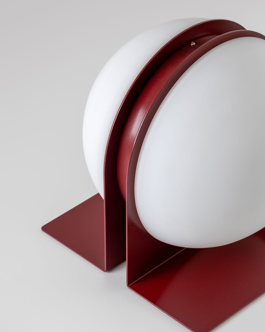 Antique red Jumelles table lamp, slightly angled view, lit