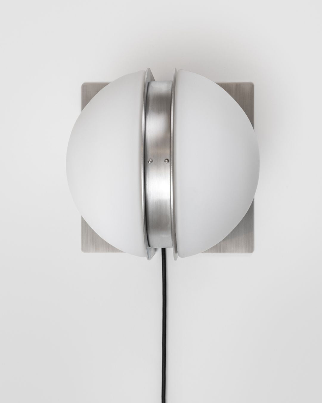 Wall-mounted Brushed aluminium Jumelles lamp, front view, lit 