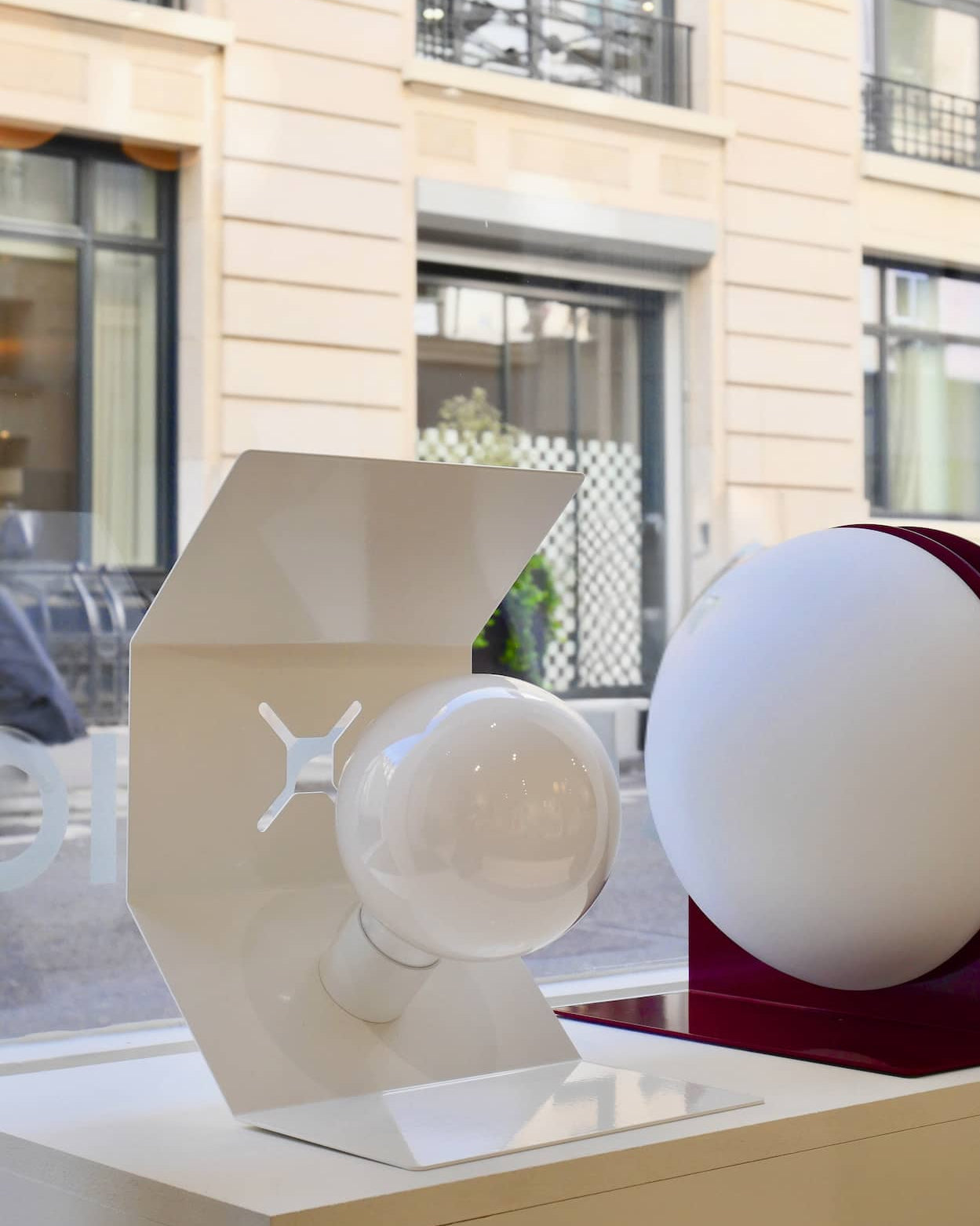 White Pliée lamp, table version on display in the window of our Paris showroom