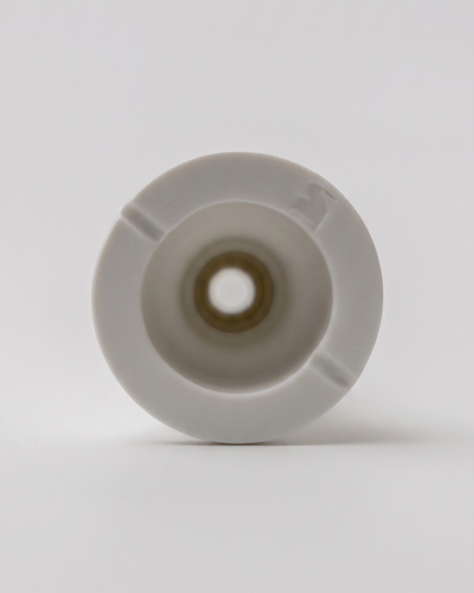 Underside view of the Miniflore minimalist unglazed porcelain vase with Source Édition mark, by Claude Courtecuisse (1970)
