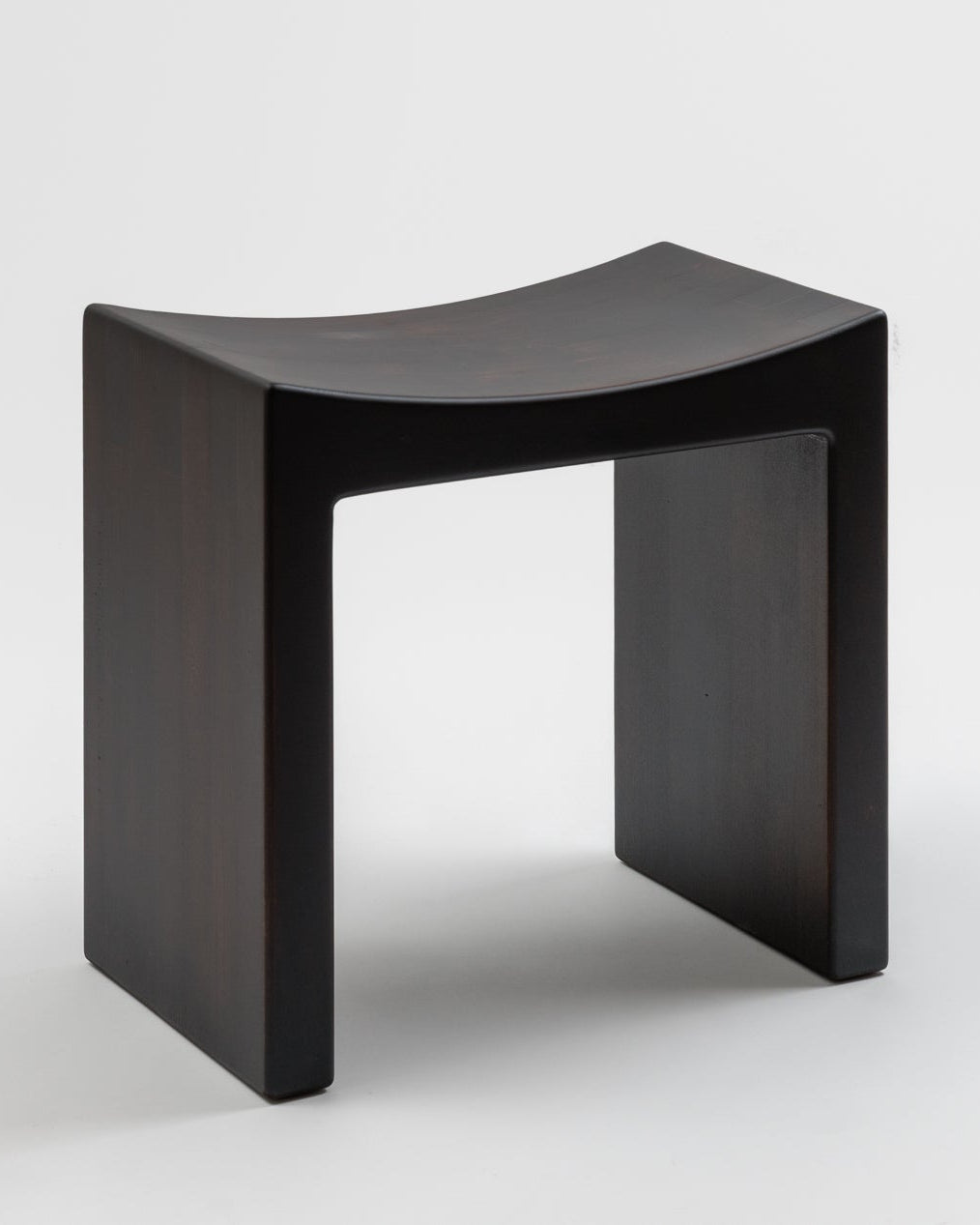 Basilio stool in solid linden with dark smooth wood finish, unique uneven tint effect