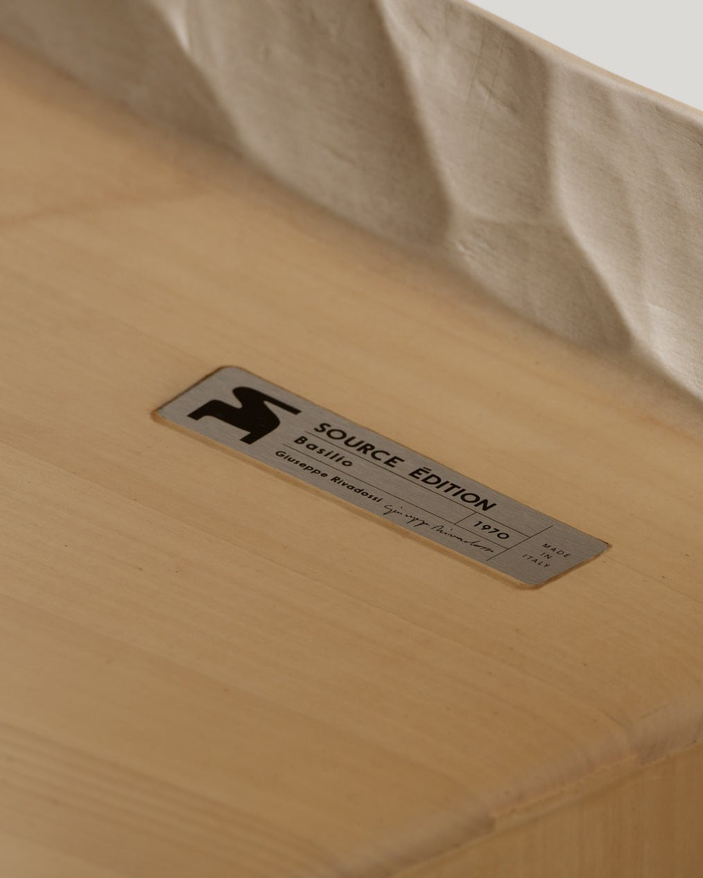 Authenticity plaque and close-up of the Basilio stool in solid linden wood with unique natural gouged wood finish 