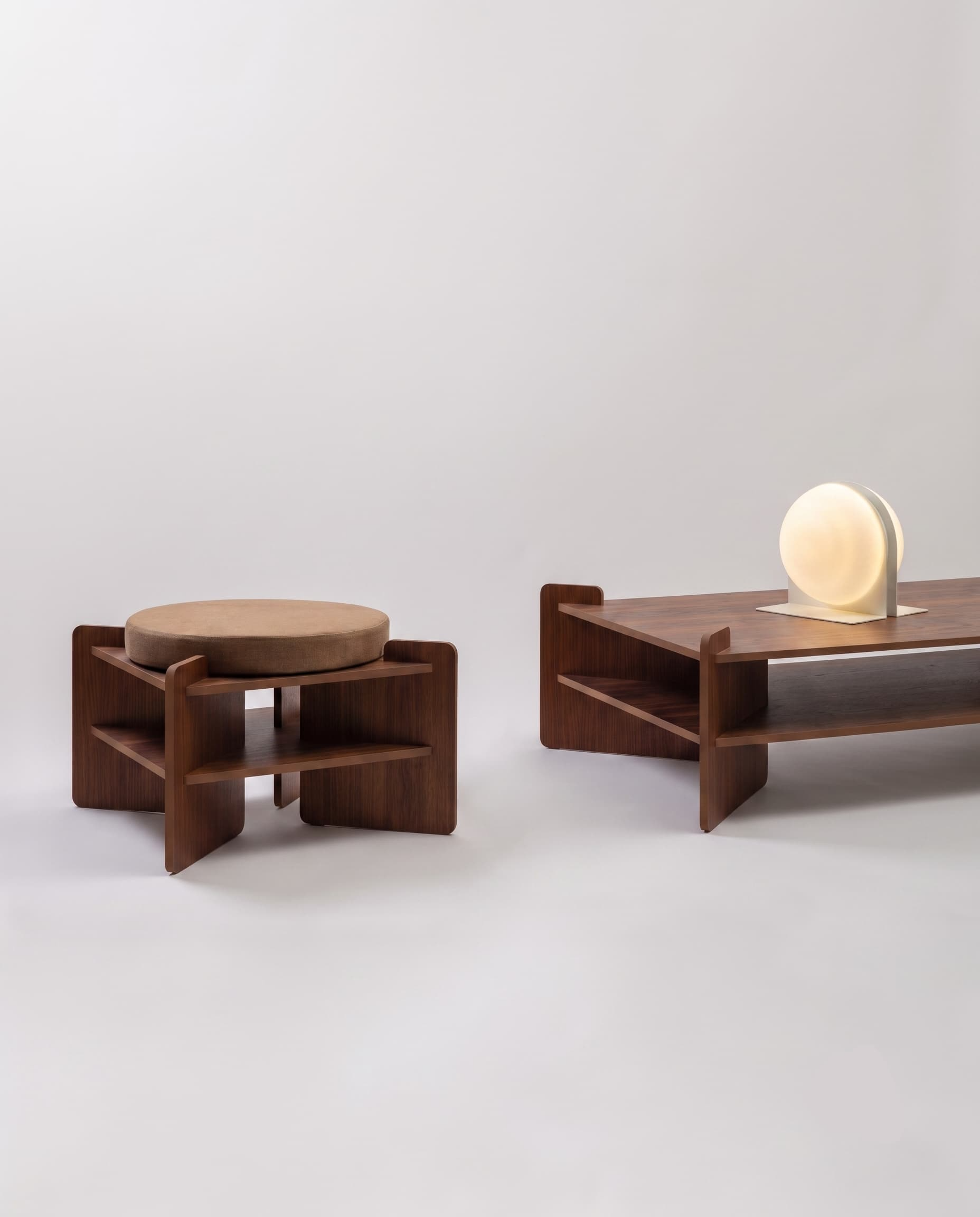 TU-TU side table, walnut veneer, used as a pouf with a Hazelnut brown seat cushion, beside the TU-TU coffee table in walnut veneer with the Jumelles lamp in white, switched on, front view