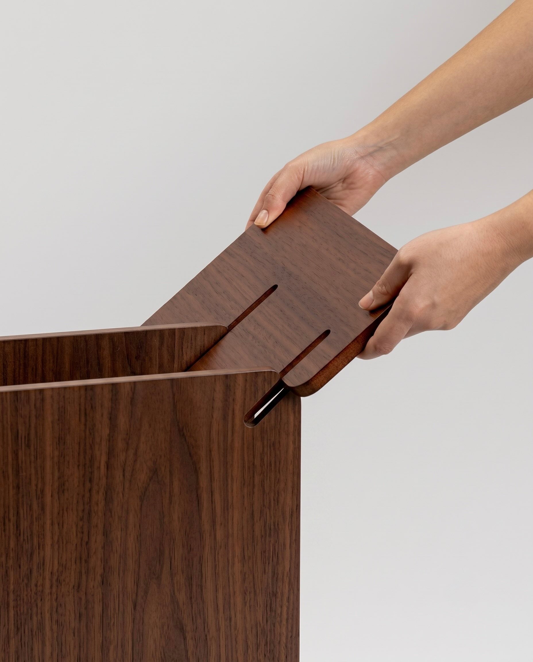 TU-TU side table, walnut veneer, a person assembling the table