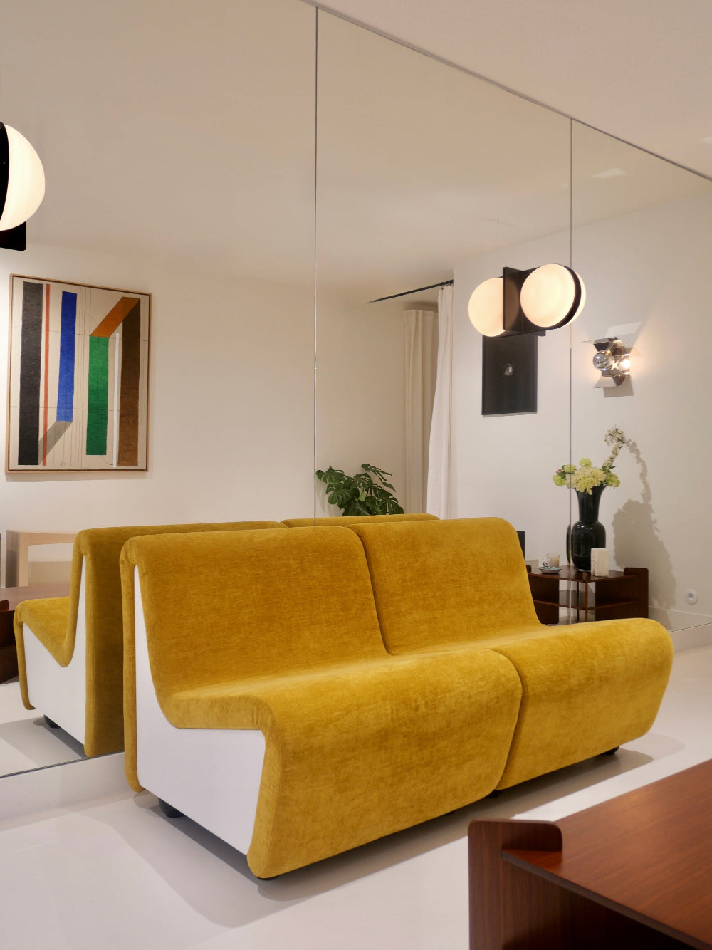 Dialogue lounge chairs in yellow fabric and white lacquered wood side panels.