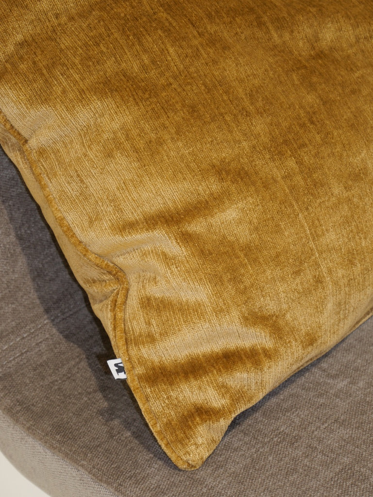 Close-up of the gold decorative cushion in velvety Italian fabric
